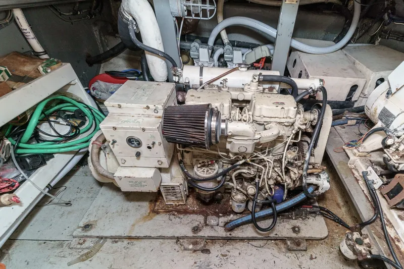 Maverick Yacht Photos Pics Engine room of a 1979 Hatteras 58 Motor Yacht with visible machinery and wiring.