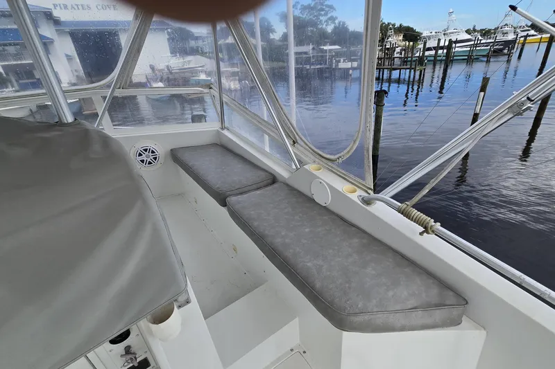 Wild Life Yacht Photos Pics 1989 Viking 45 Convertible boat interior with cushioned seating and marina view.