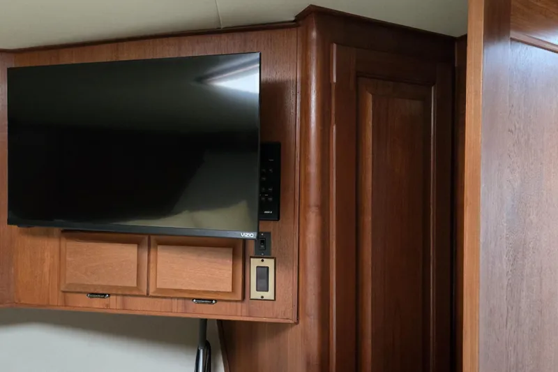 Wild Life Yacht Photos Pics Flat-screen TV mounted on wood paneling inside a 1989 Viking 45 Convertible boat.