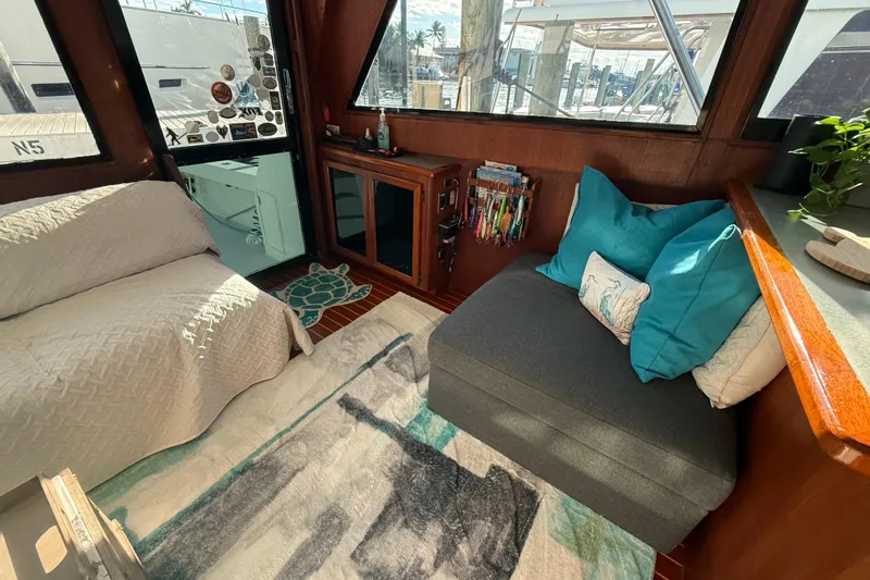 Wild Life Yacht Photos Pics Cozy interior of 1989 Viking 45 Convertible yacht with seating, pillows, and decor.