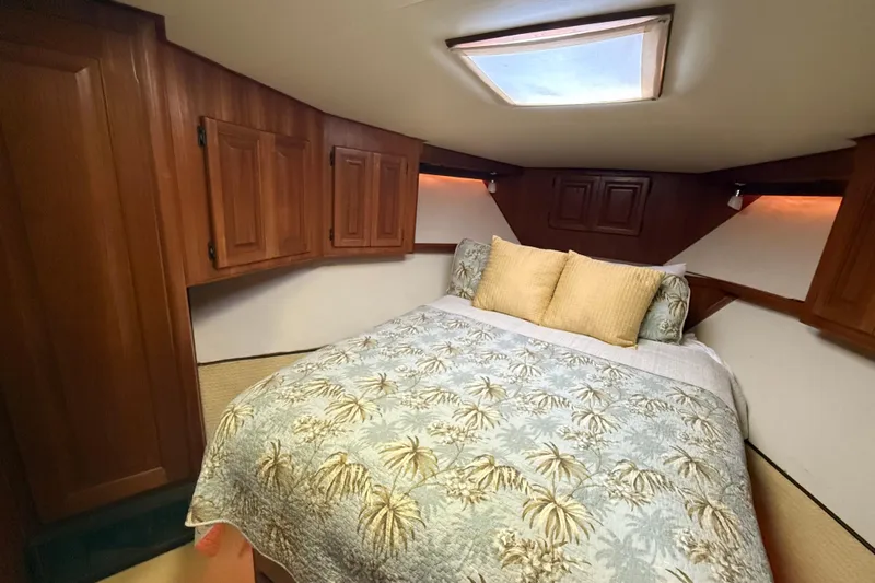 Wild Life Yacht Photos Pics Cozy bedroom in 1989 Viking 45 Convertible yacht with wood cabinets and skylight.