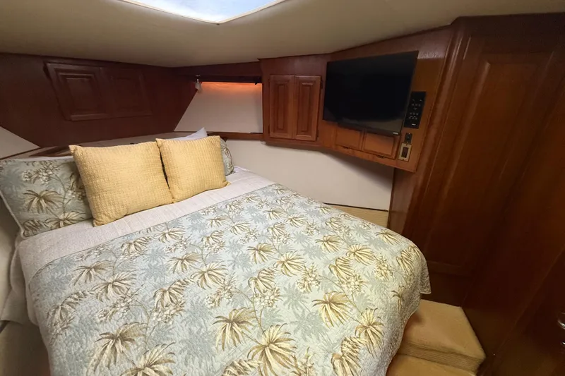 Wild Life Yacht Photos Pics Cozy bedroom in 1989 Viking 45 Convertible yacht with floral bedding and TV.