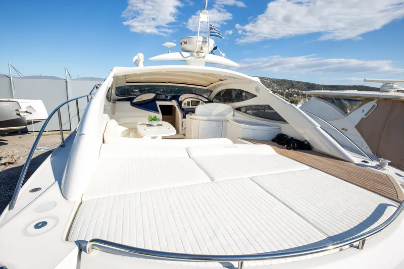  Yacht Photos Pics 2002 Pershing 52 yacht with spacious deck and luxurious seating under clear blue sky.