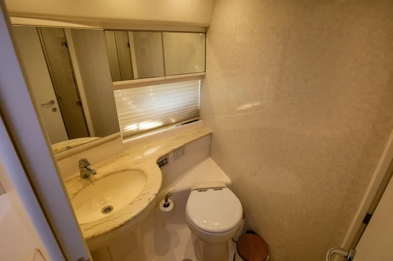  Yacht Photos Pics Luxurious bathroom in a 2002 Pershing 52 yacht with marble sink and modern fixtures.