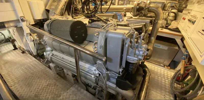  Yacht Photos Pics Engine room of a 2008 Mangusta 72 yacht, showcasing mechanical components and piping.