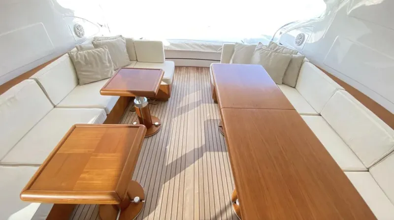  Yacht Photos Pics Luxurious 2008 Mangusta 72 yacht interior with elegant wooden tables and plush seating.