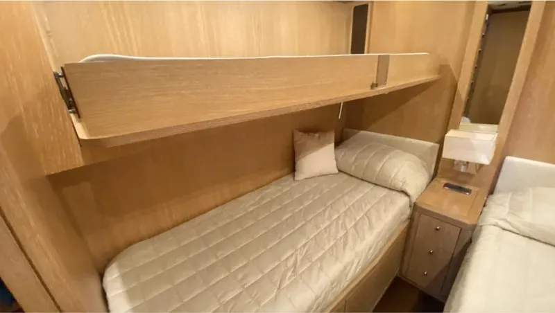  Yacht Photos Pics Luxurious cabin interior of 2008 Mangusta 72 yacht with twin beds and wooden finish.