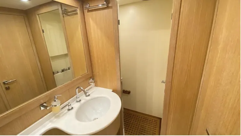  Yacht Photos Pics Luxurious bathroom interior of 2008 Mangusta 72 yacht with modern fixtures and wooden accents.