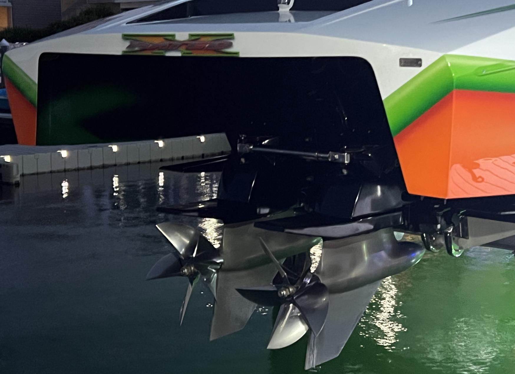 2015 Outerlimits SL-50 boat with dual propellers in water at night.