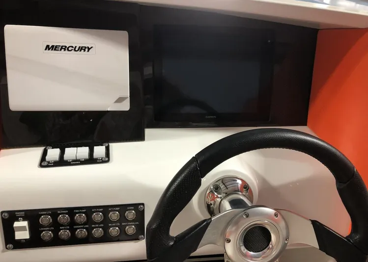  Yacht Photos Pics 2015 Outerlimits SL-50 boat dashboard with Mercury controls and steering wheel.