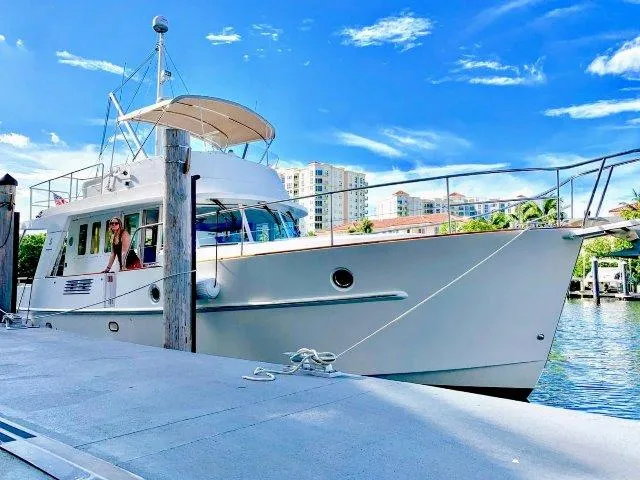 Aquavit Yacht Photos Pics 2006 Beneteau Swift Trawler 42 docked by waterfront, clear sky background.