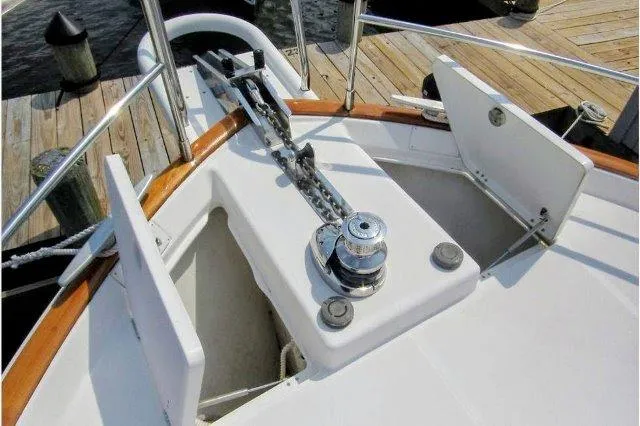 Aquavit Yacht Photos Pics Anchor system on 2006 Beneteau Swift Trawler 42, docked with open storage compartments.