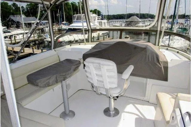 Aquavit Yacht Photos Pics 2006 Beneteau Swift Trawler 42 flybridge with seating, helm chair, and marina view.