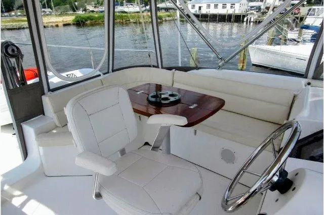 Aquavit Yacht Photos Pics 2006 Beneteau Swift Trawler 42 cockpit with seating, table, and steering wheel.