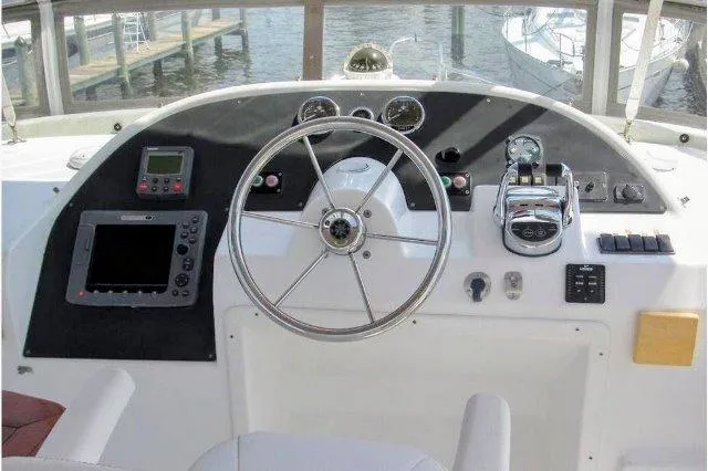 Aquavit Yacht Photos Pics Helm of 2006 Beneteau Swift Trawler 42 with navigation instruments and steering wheel.