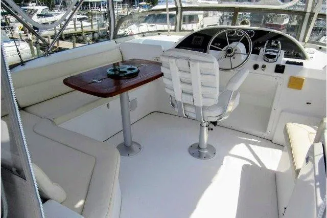 Aquavit Yacht Photos Pics 2006 Beneteau Swift Trawler 42 helm with seating and wooden table.