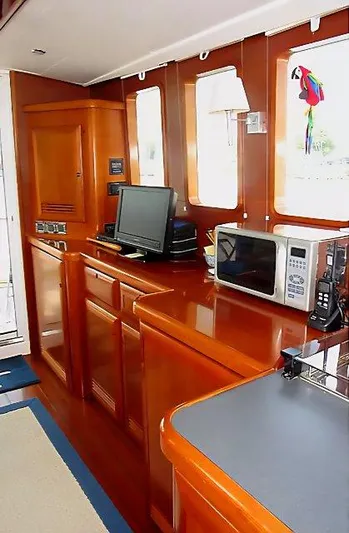 Aquavit Yacht Photos Pics 2006 Beneteau Swift Trawler 42 interior with wood cabinetry, microwave, and computer setup.