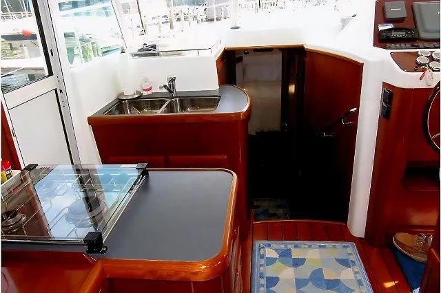 Aquavit Yacht Photos Pics 2006 Beneteau Swift Trawler 42 interior with kitchen, sink, and stairs.