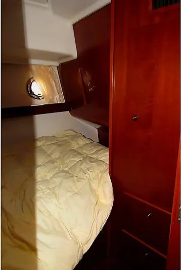 Aquavit Yacht Photos Pics 2006 Beneteau Swift Trawler 42 cabin with wooden interior and cozy bed.
