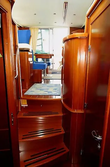 Aquavit Yacht Photos Pics Interior view of 2006 Beneteau Swift Trawler 42, featuring wooden stairs and seating area.