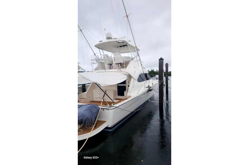 Last Dance Yacht Photos Pics 2006 Riviera 47 Open Flybridge Series II yacht docked on a rainy day.