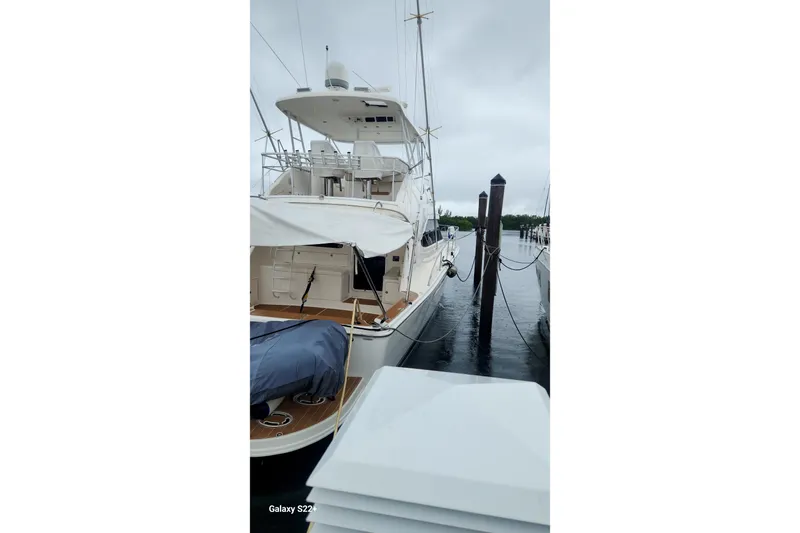 Last Dance Yacht Photos Pics 2006 Riviera 47 Open Flybridge Series II yacht docked on a cloudy day.