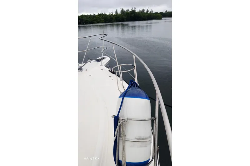 Last Dance Yacht Photos Pics Bow view of 2006 Riviera 47 Open Flybridge Series II on calm water.