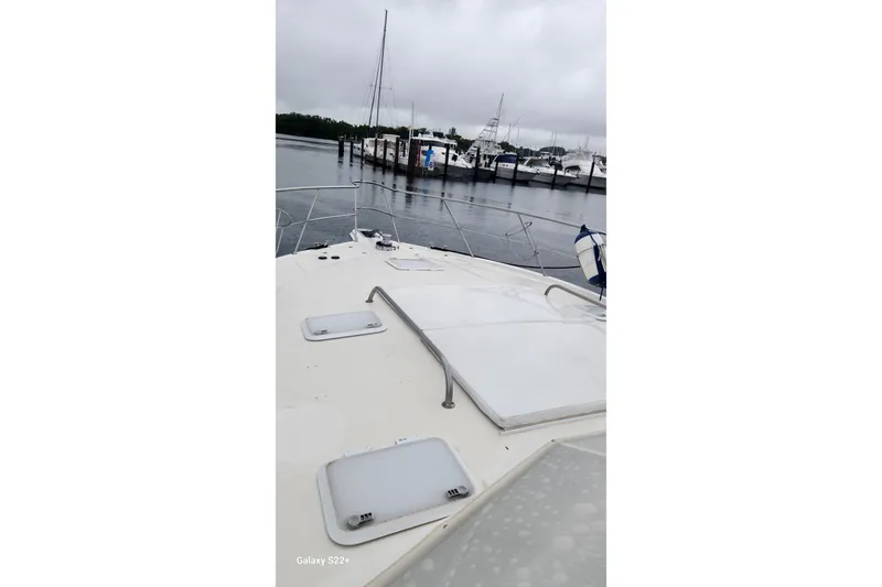 Last Dance Yacht Photos Pics 2006 Riviera 47 Open Flybridge Series II yacht docked on a cloudy day.