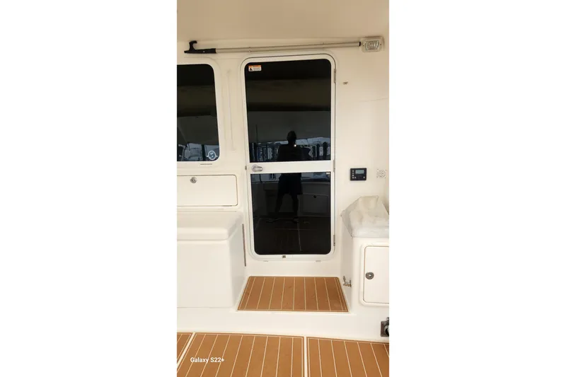 Last Dance Yacht Photos Pics 2006 Riviera 47 Open Flybridge Series II yacht interior with sliding door and teak flooring.