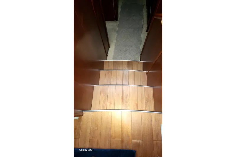 Last Dance Yacht Photos Pics Wooden steps inside a 2006 Riviera 47 Open Flybridge Series II yacht.