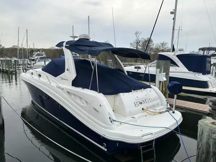  Yacht Photos Pics 2005 Sea Ray 340 Sundancer docked at a marina with blue canvas covers.