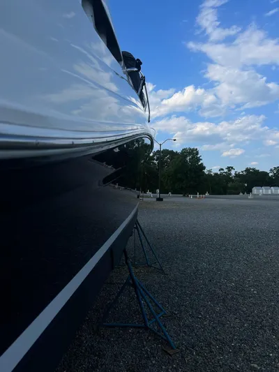  Yacht Photos Pics 2005 Sea Ray 340 Sundancer boat on stands, side view, clear sky background.