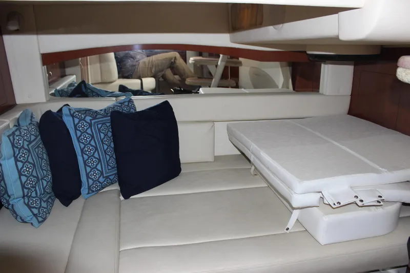  Yacht Photos Pics Interior cabin of 2005 Sea Ray 340 Sundancer with blue and white cushions.