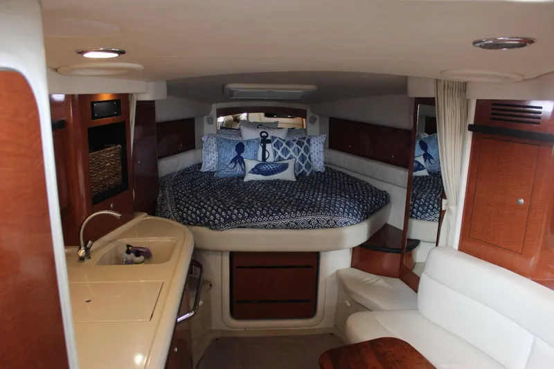  Yacht Photos Pics Interior cabin of a 2005 Sea Ray 340 Sundancer with bed, kitchenette, and seating area.