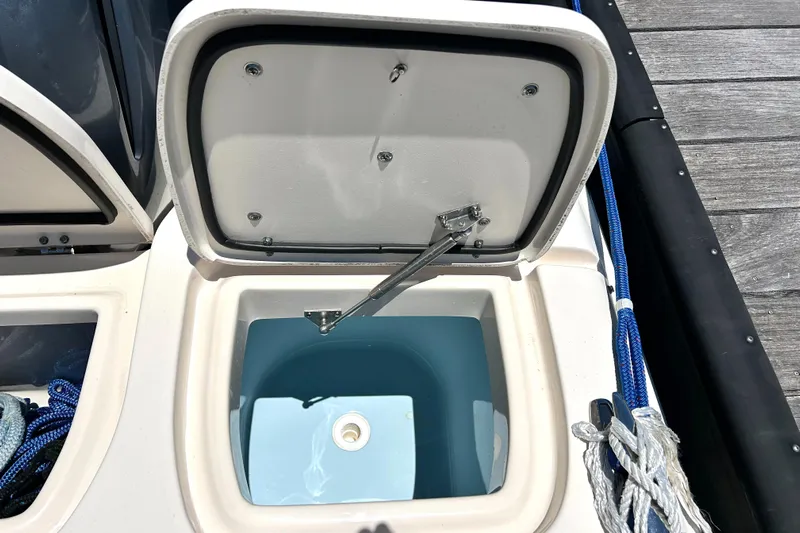  Yacht Photos Pics Open storage compartment on 2020 Grady-White Freedom 275 boat, showing interior details.