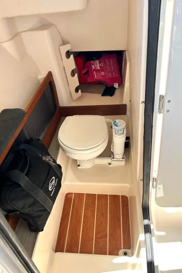  Yacht Photos Pics 2020 Grady-White Freedom 275 boat interior with compact marine toilet and storage.