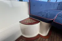 Interboat 21 Classic 2000 interior with blue cushioned seating and wooden flooring.