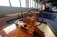 Interior of 2000 Interboat 21 Classic with wooden steering wheel and cup holders.