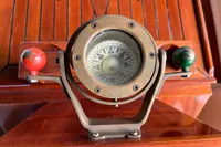 Vintage compass on Interboat 21 Classic, wooden background, nautical theme, 2000 model.