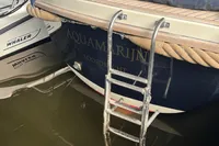 Interboat 21 Classic boat with ladder, docked beside another vessel.