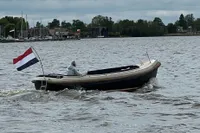 Interboat 21 Classic motorboat on a lake, 2000 model, Dutch flag, overcast sky.