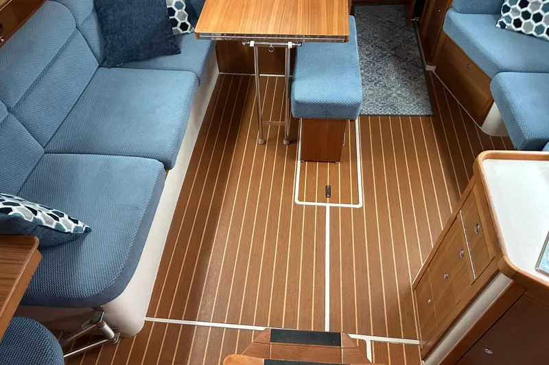  Yacht Photos Pics Interior of 2009 Catalina 375 sailboat with blue seating and wooden flooring.
