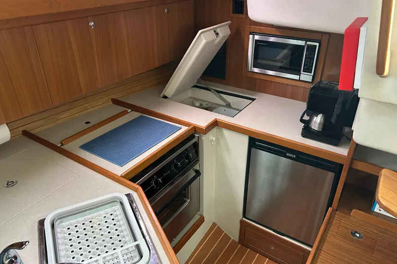 Yacht Photos Pics 2009 Catalina 375 yacht kitchen with stove, microwave, and compact fridge.