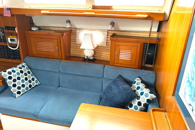  Yacht Photos Pics Interior of 2009 Catalina 375 sailboat with blue seating and decorative pillows.