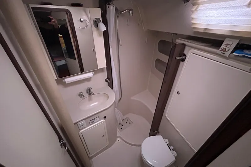  Yacht Photos Pics Compact bathroom in 2009 Catalina 375 sailboat with sink, toilet, and shower.