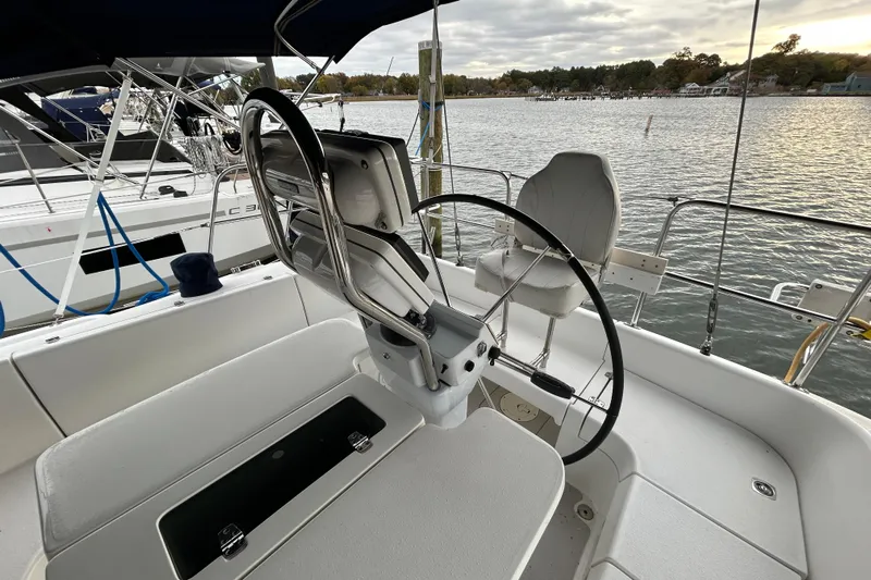  Yacht Photos Pics Cockpit of 2009 Catalina 375 sailboat with steering wheel, docked by the water.