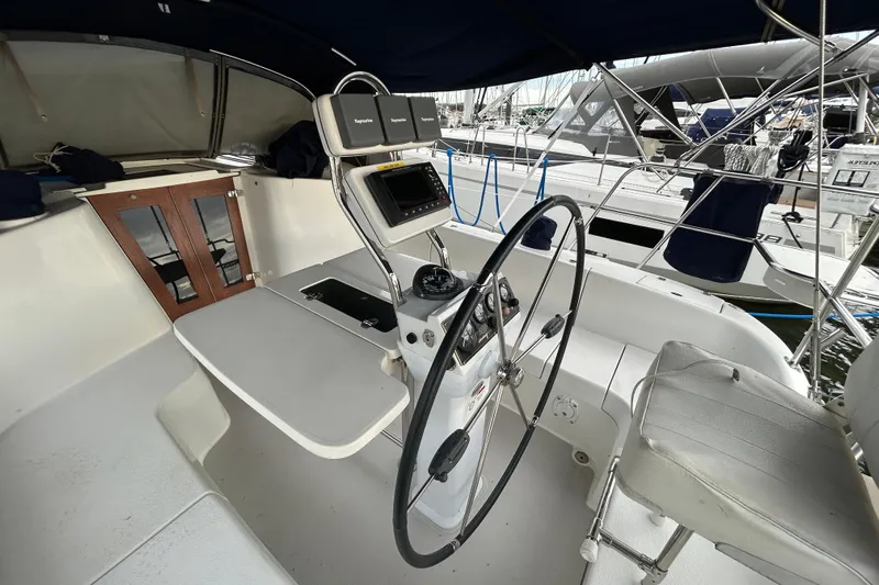  Yacht Photos Pics Cockpit of a 2009 Catalina 375 sailboat with steering wheel and navigation equipment.