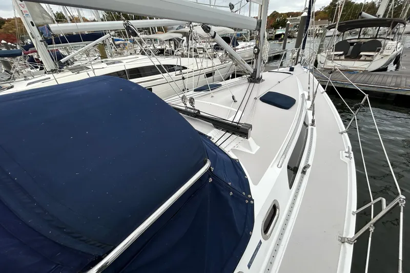  Yacht Photos Pics 2009 Catalina 375 sailboat docked at marina, featuring blue canvas cover.