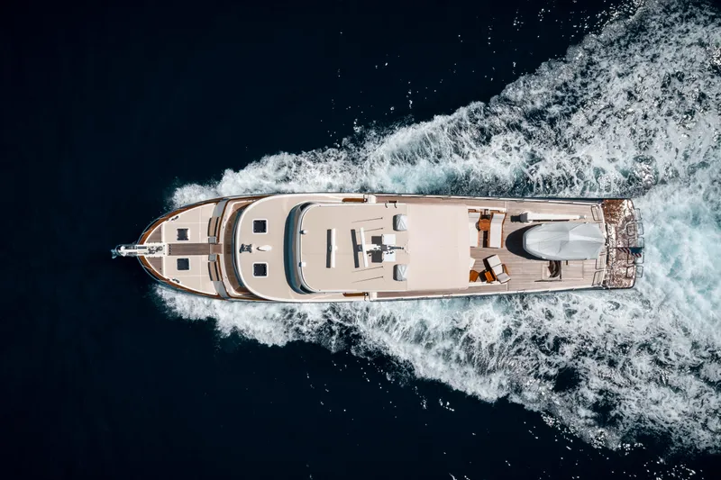 Rat Pack Yacht Photos Pics Aerial view of 2011 Marlow Explorer yacht cruising through deep blue ocean waters.