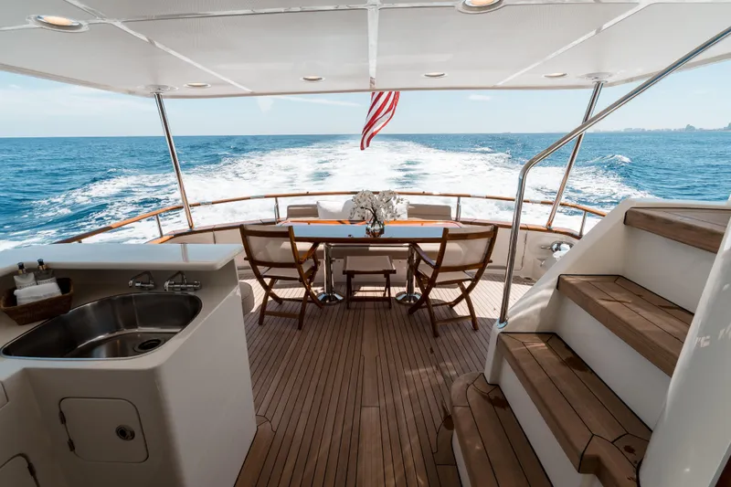 Rat Pack Yacht Photos Pics Luxurious 2011 Marlow Explorer yacht deck with ocean view, dining area, and American flag.